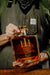 Man Holding Whiskey Bottle